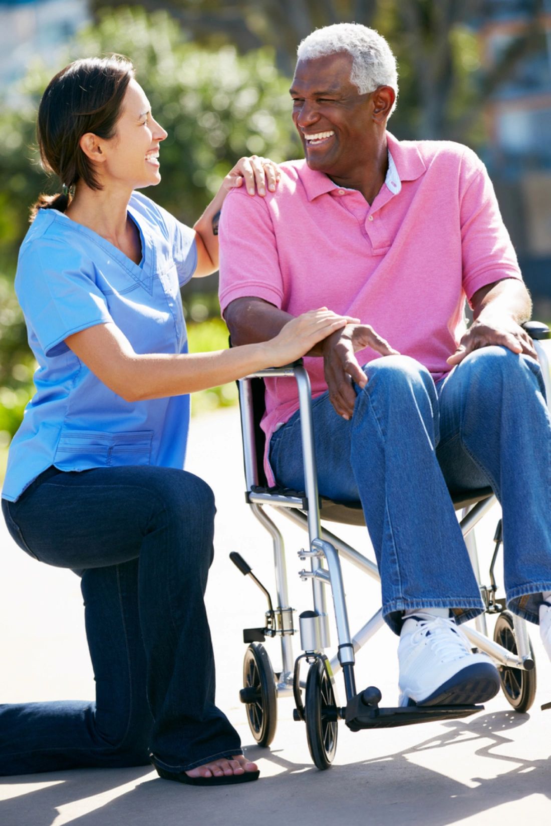 Healthcare worker with elderly patient outdoors